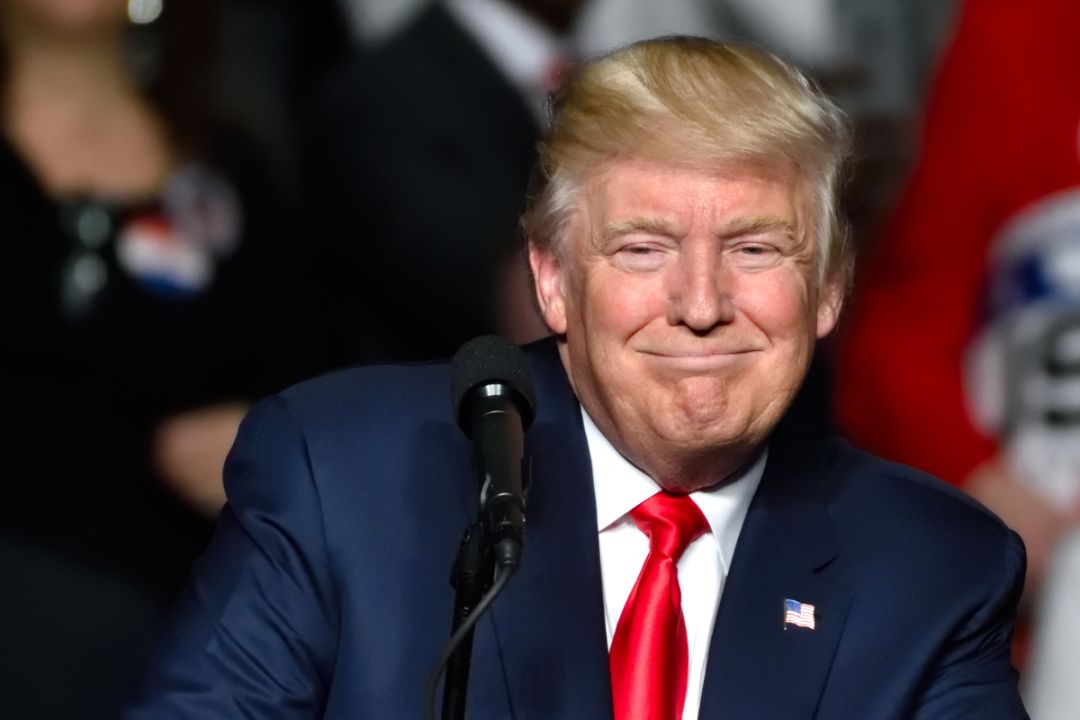 United States President Donald Trump smiling at a rally
