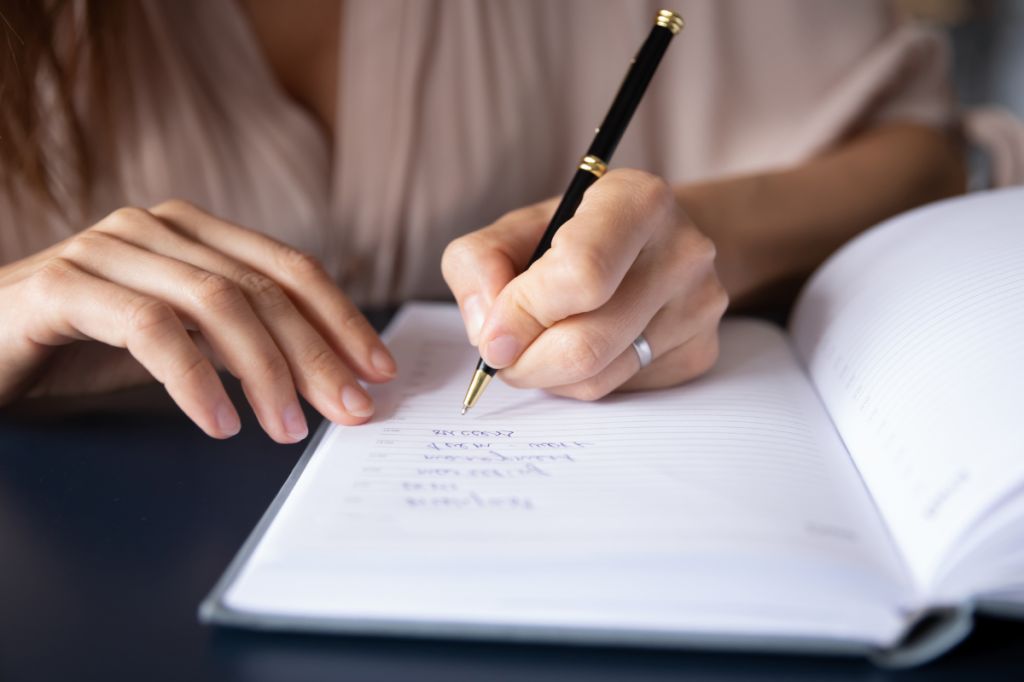 woman making list of pros and cons of having a baby