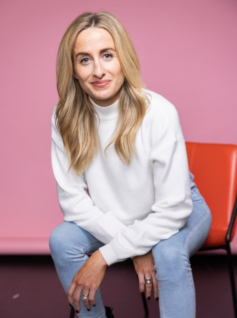 dr julie smith wearing white jumper sitting on chair