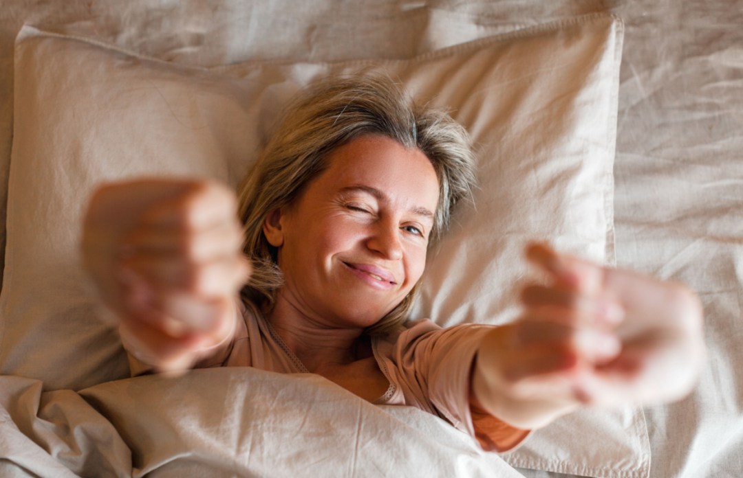 woman sleeping waking up happy