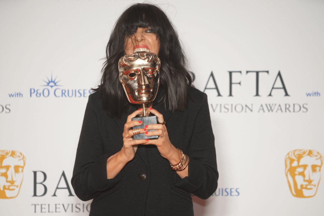 Claudia Winkleman biting her BAFTA award