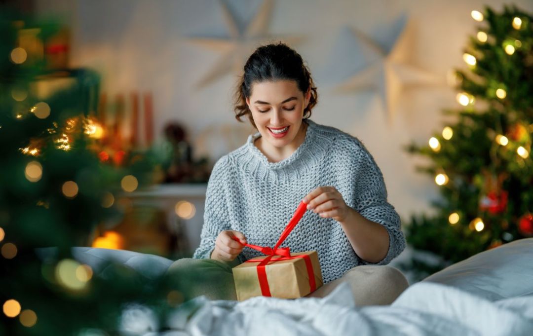 woman unwrapping christmas gift