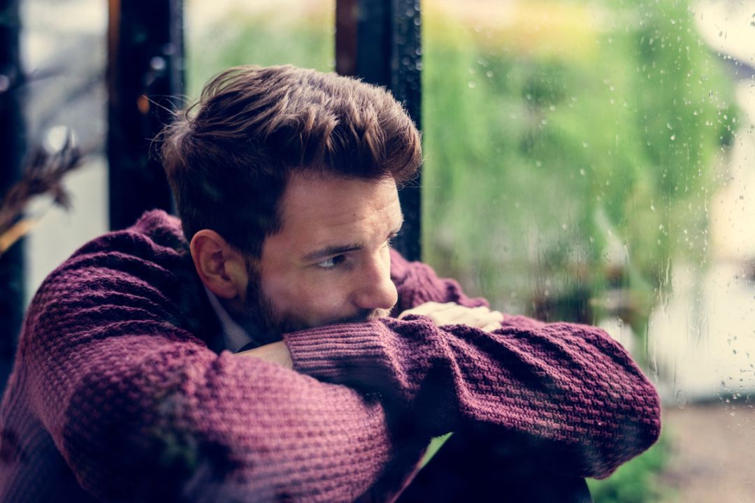 man feeling distant, struggling to express emotions