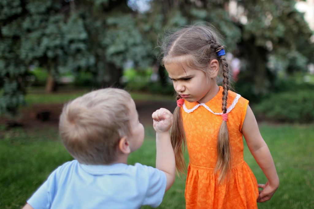 girl and boy look angrily at each other