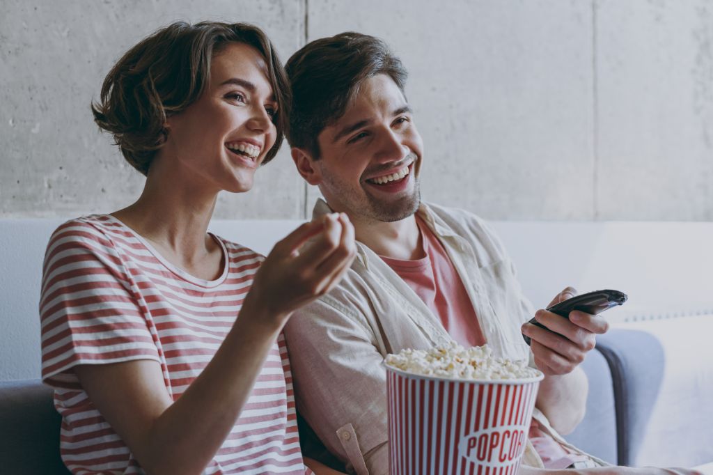 Couple share a bucket of popcorn