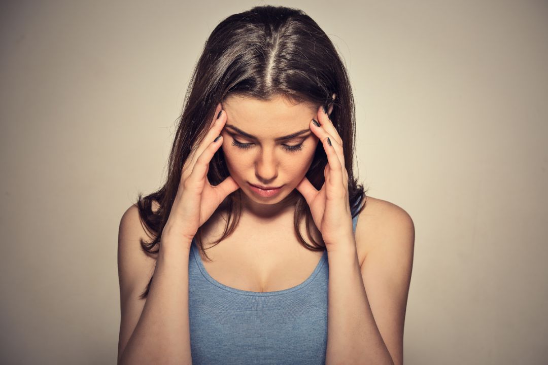 woman holding head and wondering Could I have ADHD