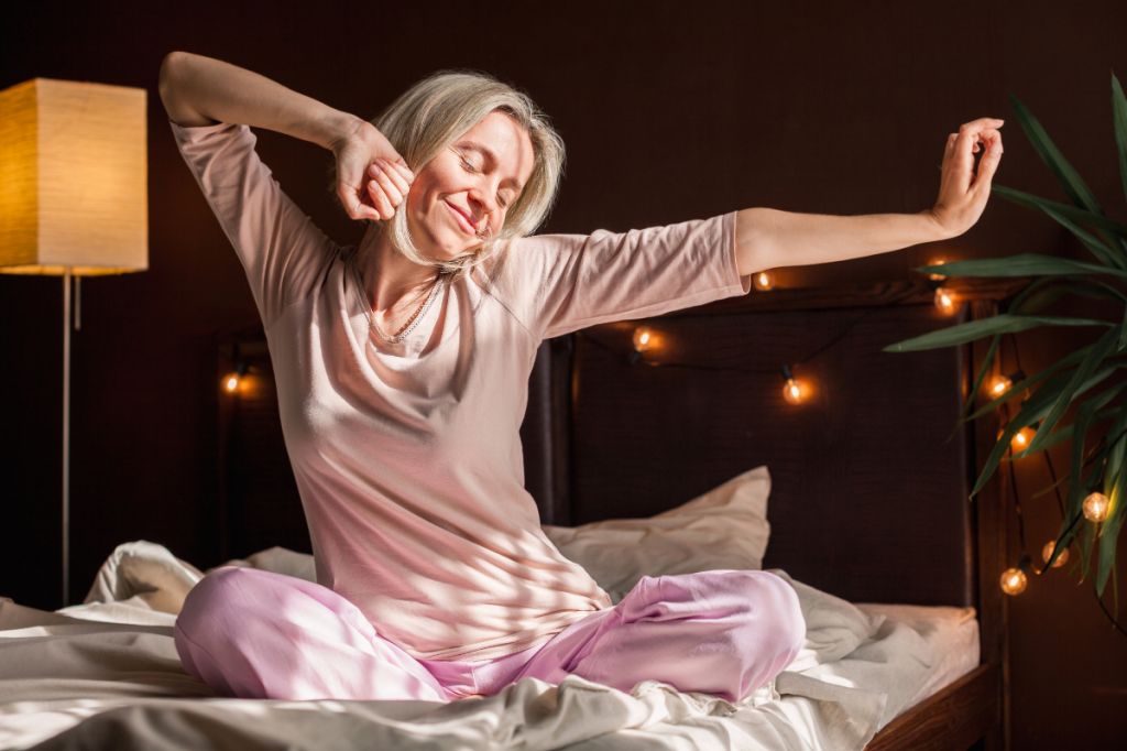 relaxed woman stretches after a good night sleep
