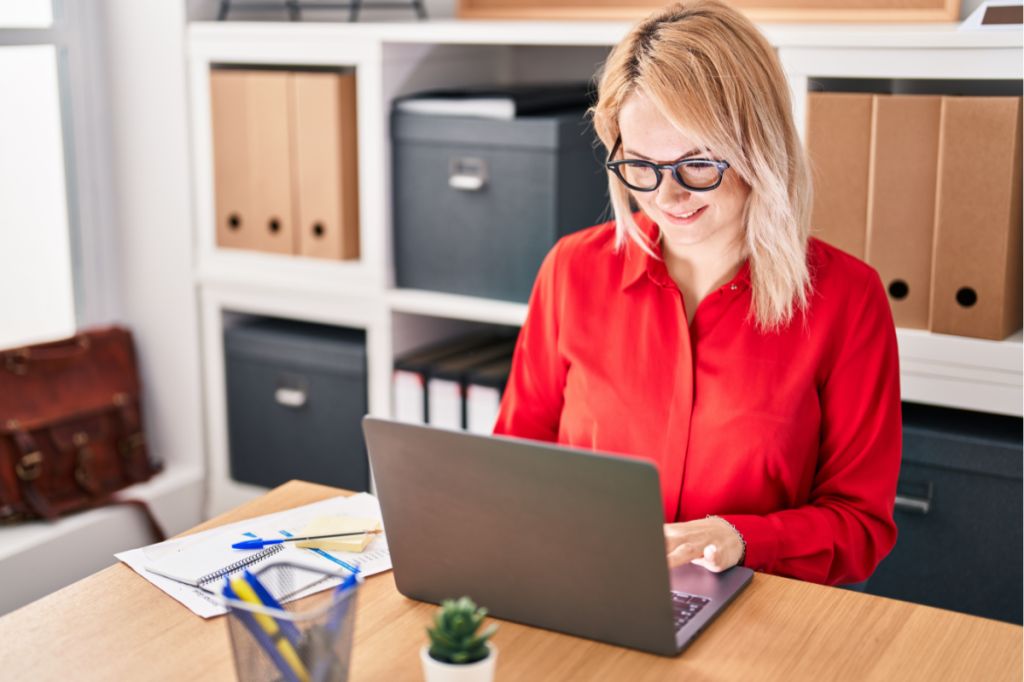woman happy typing at computer, not using ai