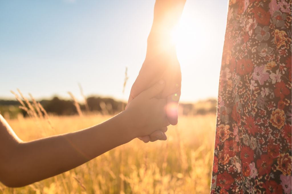 Parent and child hold hands