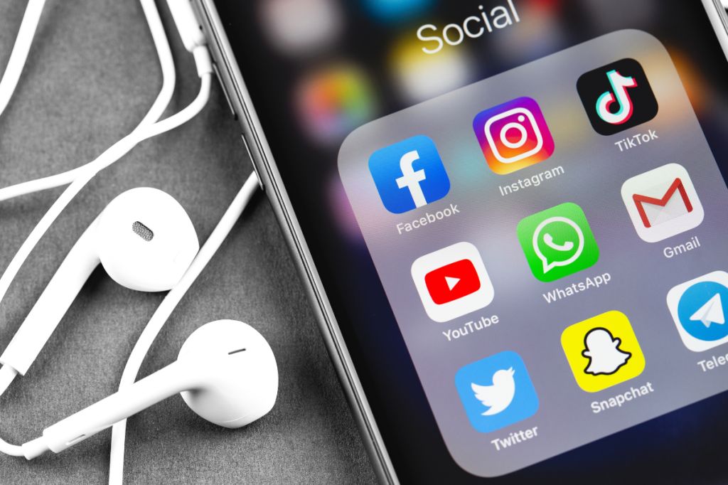 the phone in close up with social media on the screen