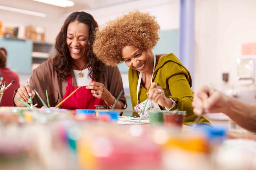 happy women in midlife painting together