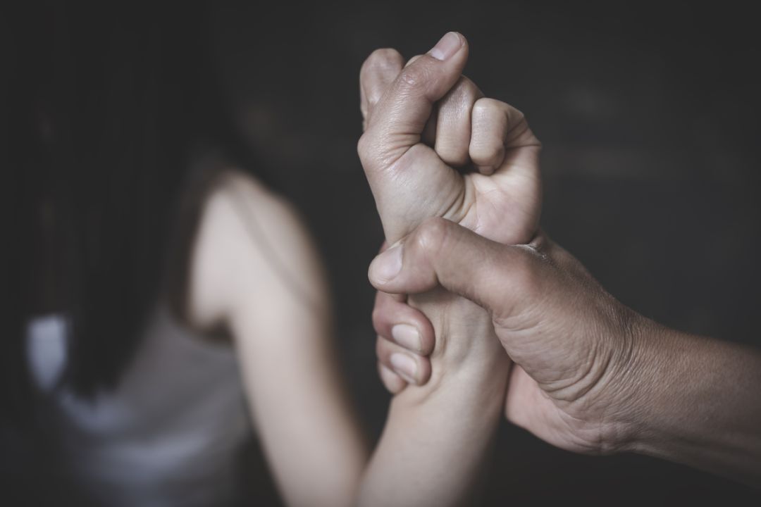 man holds woman's arm