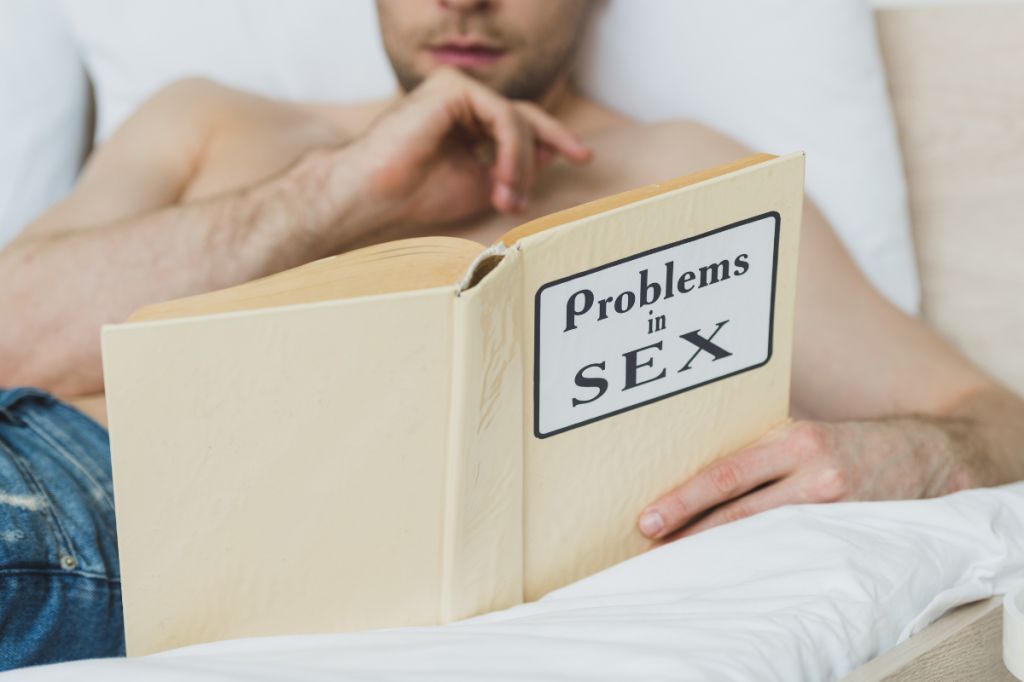 man reading book about sex addiction