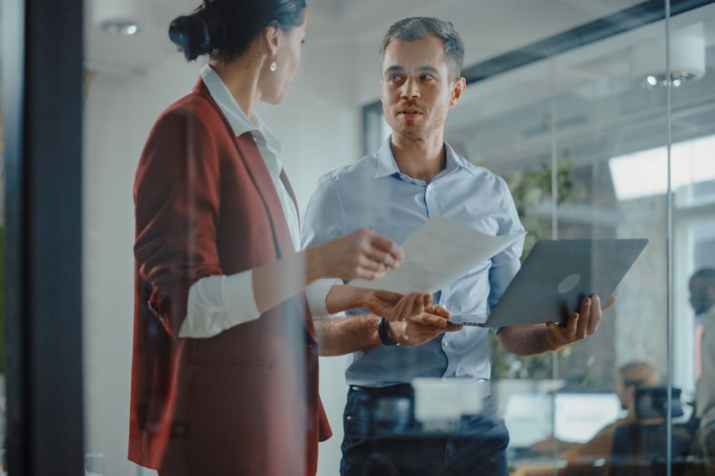 man and woman in conversation in the office