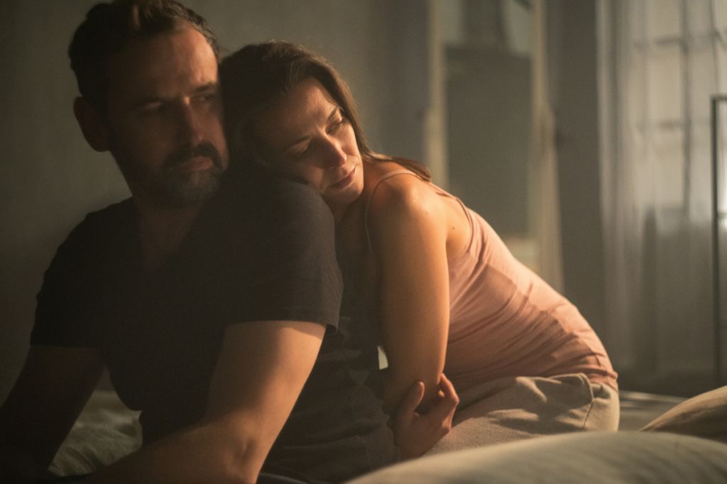 woman cuddles man from behind