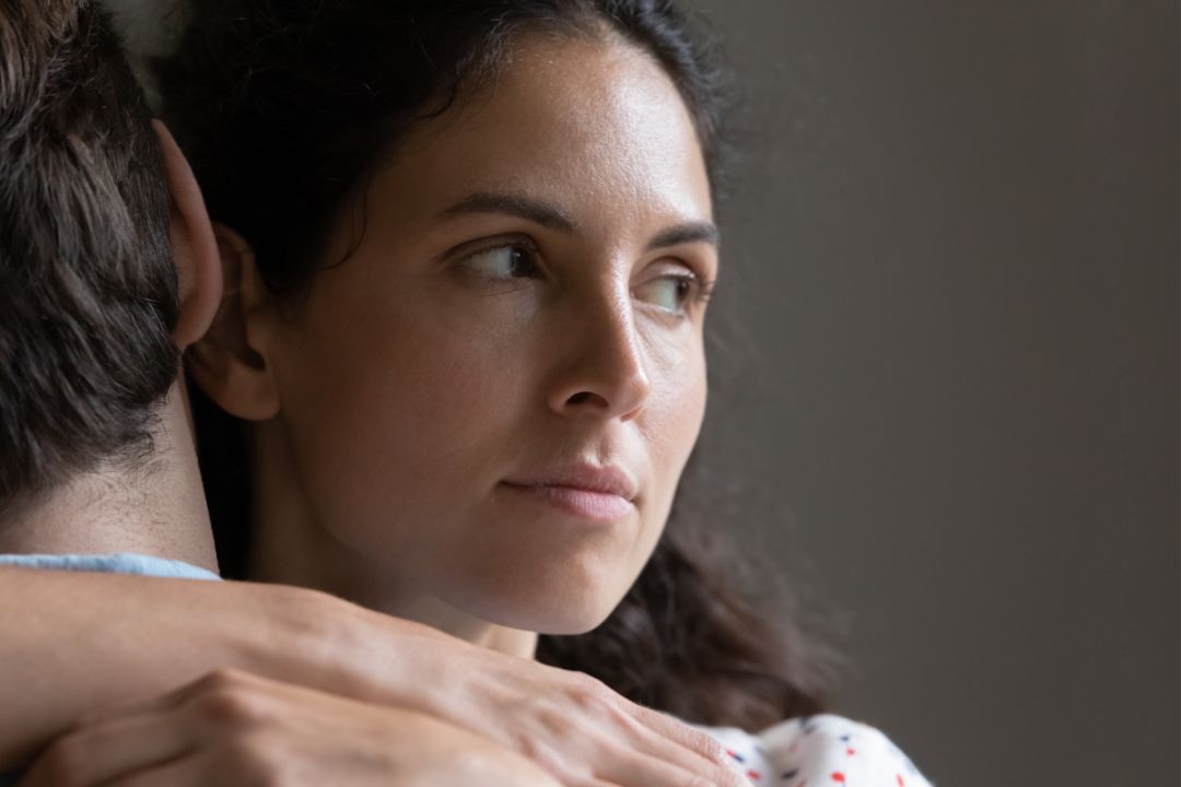 woman unhappy hugging man