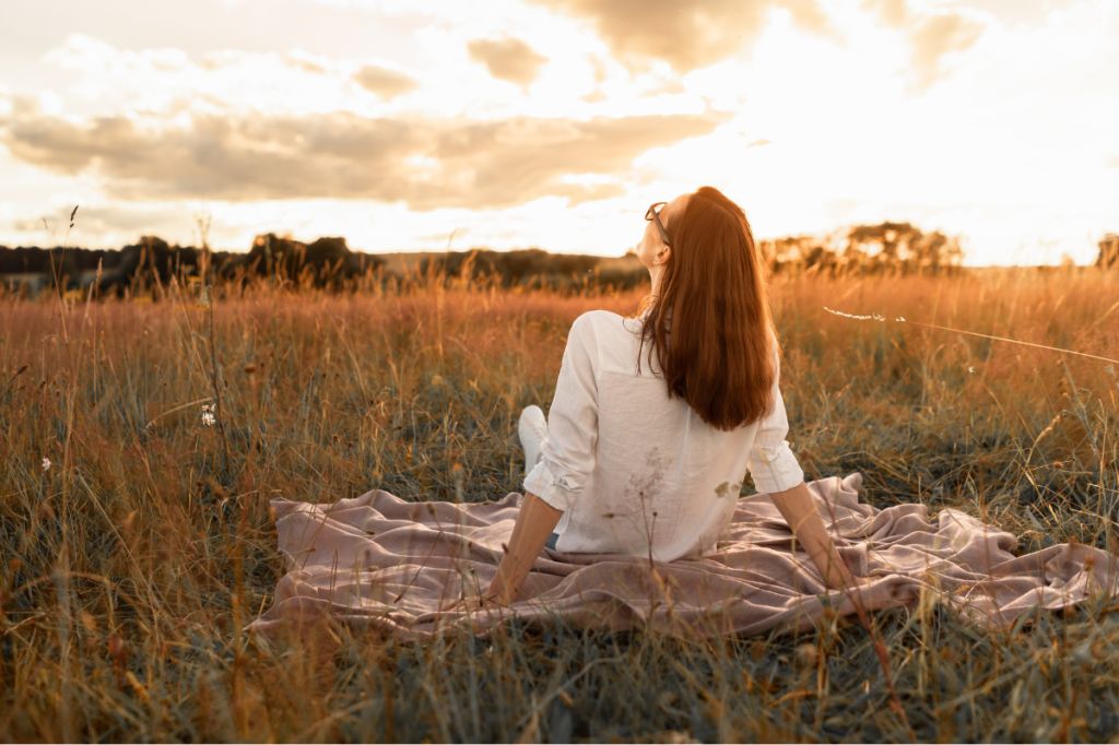 woman relaxes in a beautiful meadow