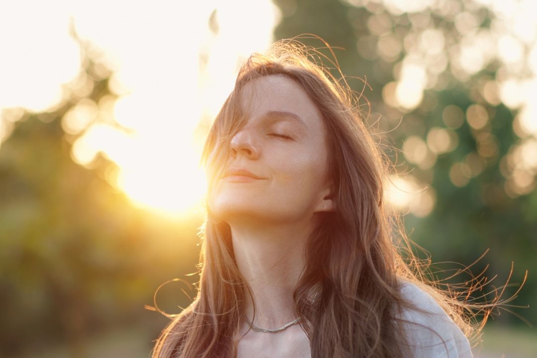 woman happy and calm with the sunset in the background