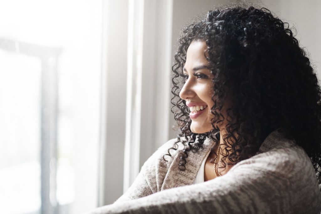 woman looks confidently out of window
