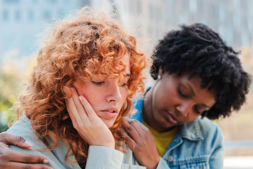 woman supports upset friend