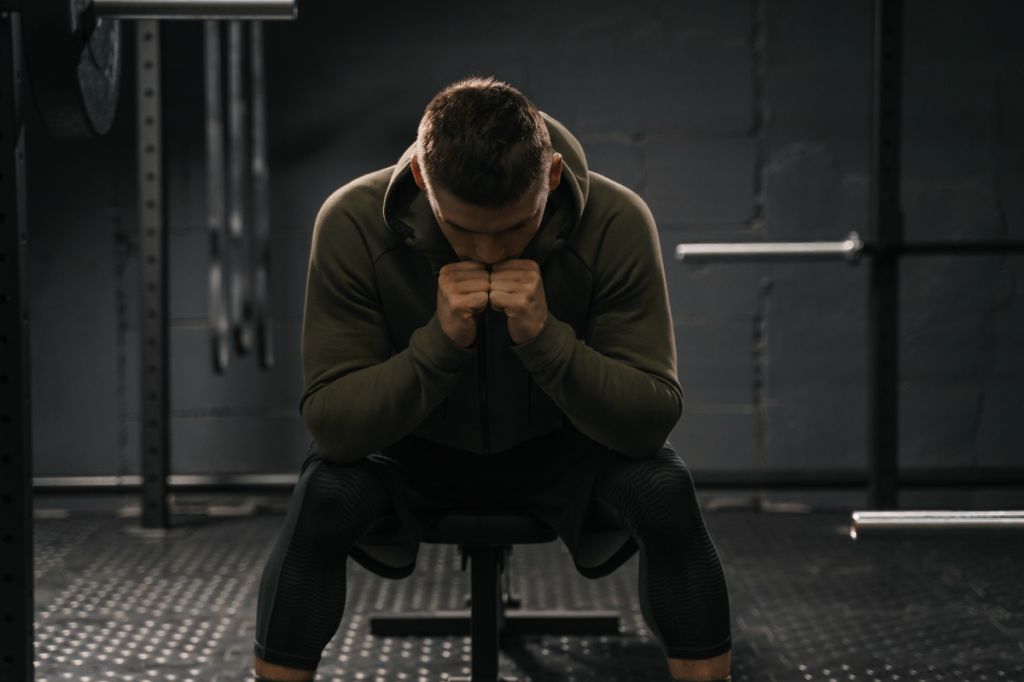 man looks sad and alone in gym