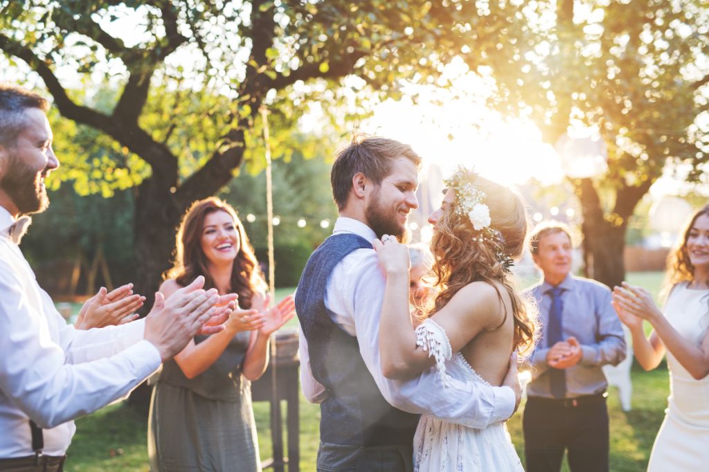 happy couple gaze at each other dancing on wedding day
