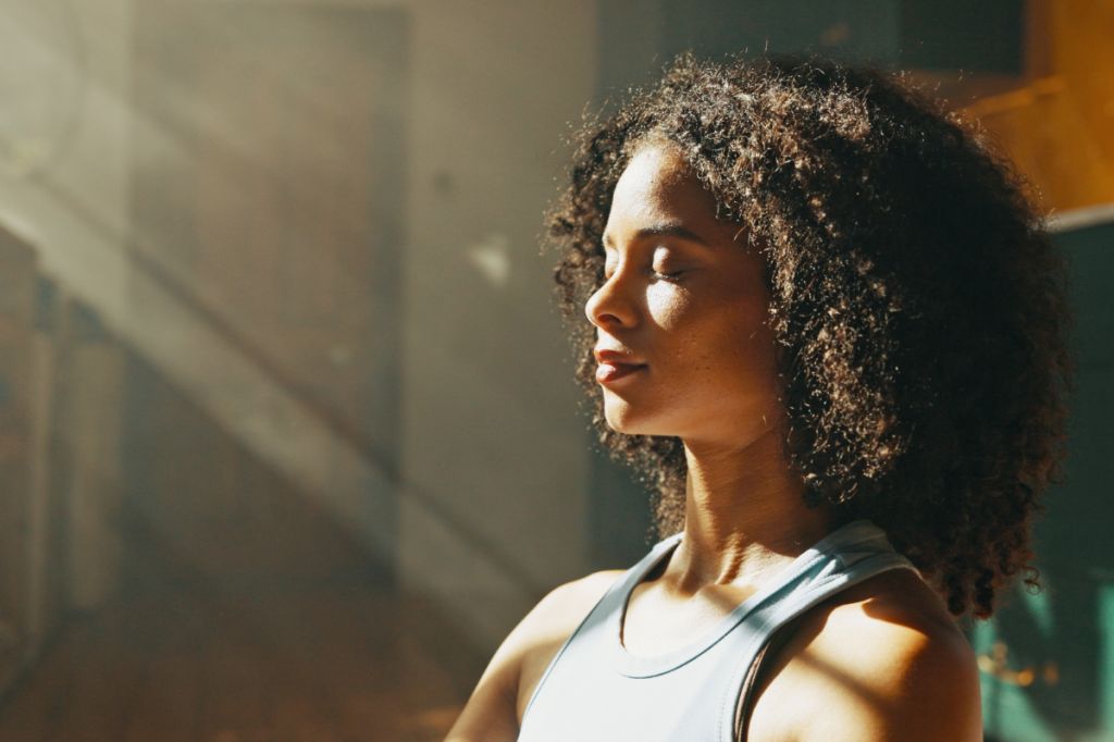 woman takes a deep breath and looks calm