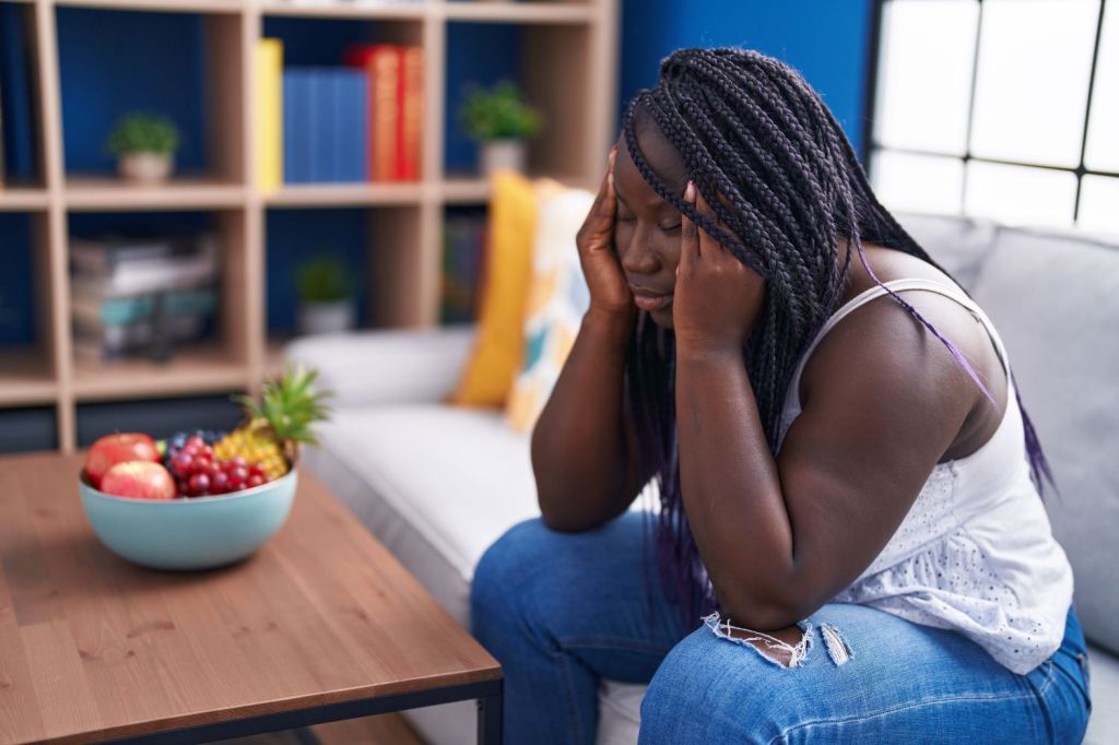 woman with head in hands, she is struggling with symptoms of anxiety and OCD