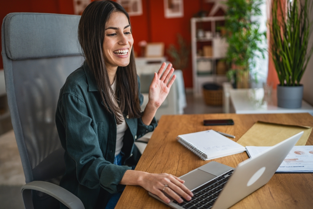 woman working from home on a video call meeting with other remote workers