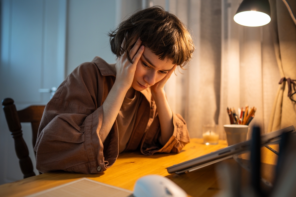woman working from home office, feeling sad and isolated