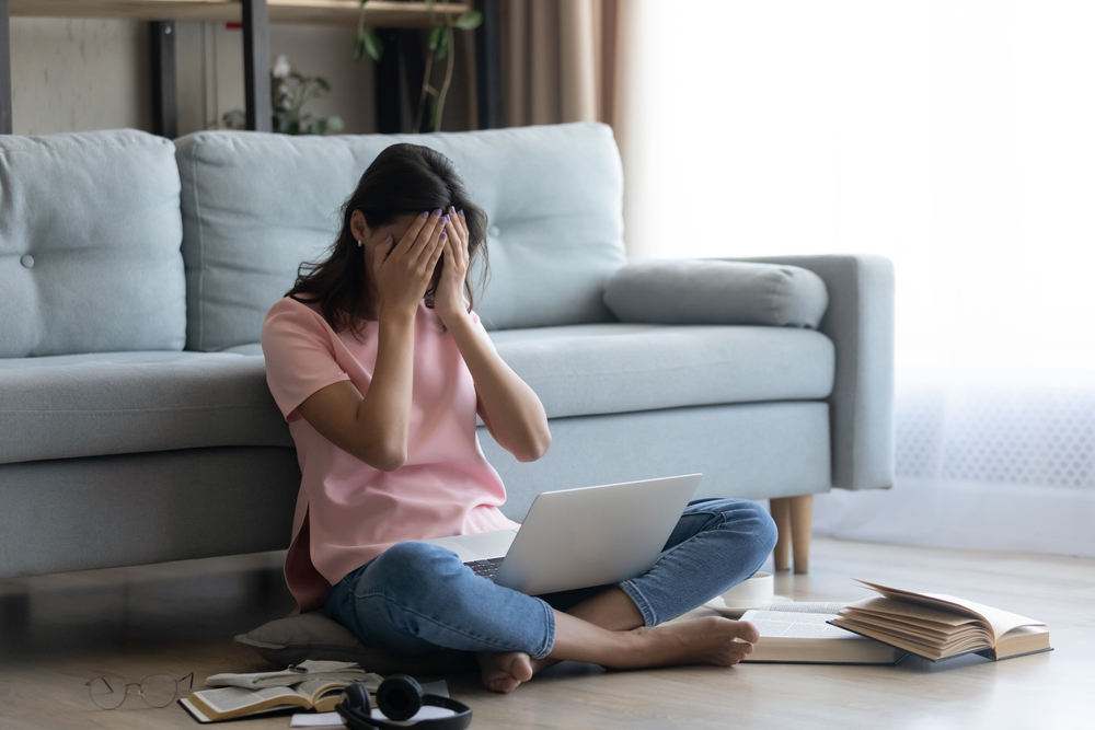 midlife woman struggling with brain fog and stress while trying to work at home