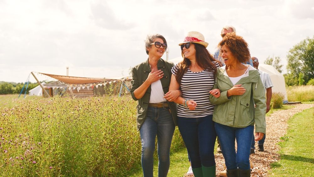 group of midlife women walking and laughing together