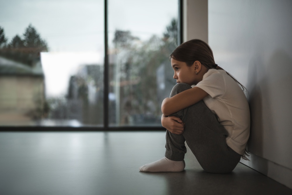 child feeling sad and lonely, concept imagery around childhood origins of anxiety and depression