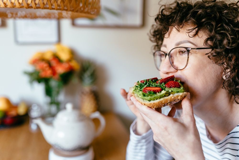 midlife woman eating healthy food, nutrition tips for neurodivergent women