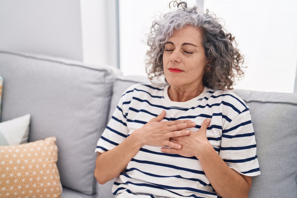 middle aged midlife woman doing breathing exercises to support emotional wellbeing during menopause