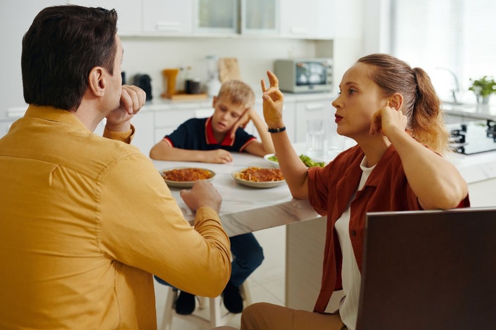 family arguing at the dinner table, parents arguing in front of child