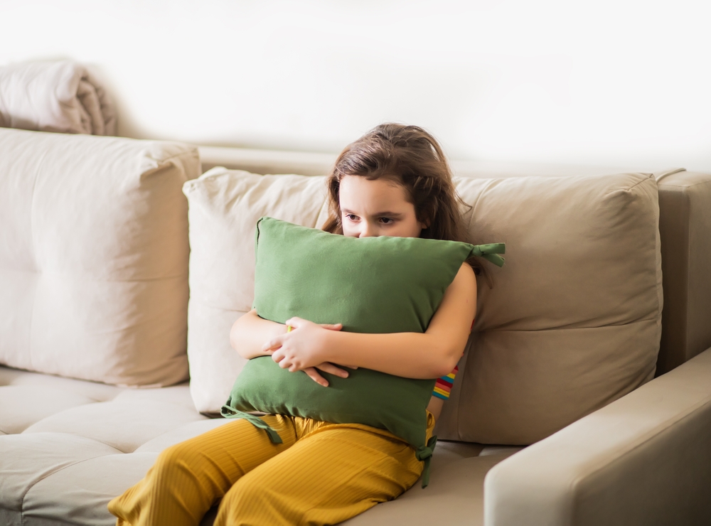 young girl feeling upset and worried, childhood origins of OCD concept