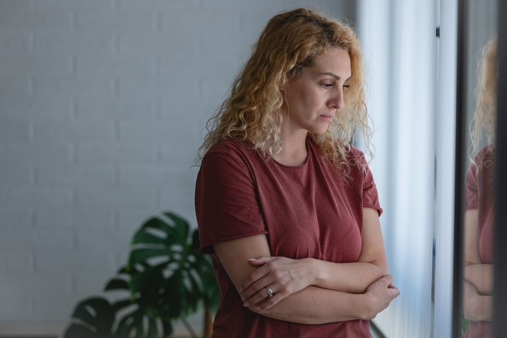 midlife woman looking sad and pensive, worried