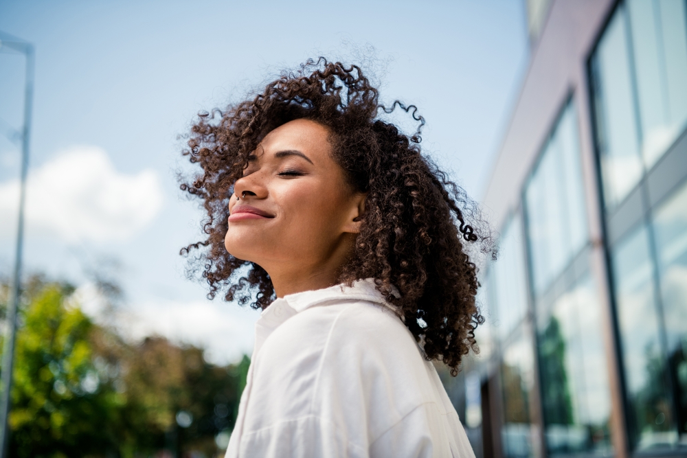 A photograph of a happy and content young woman
