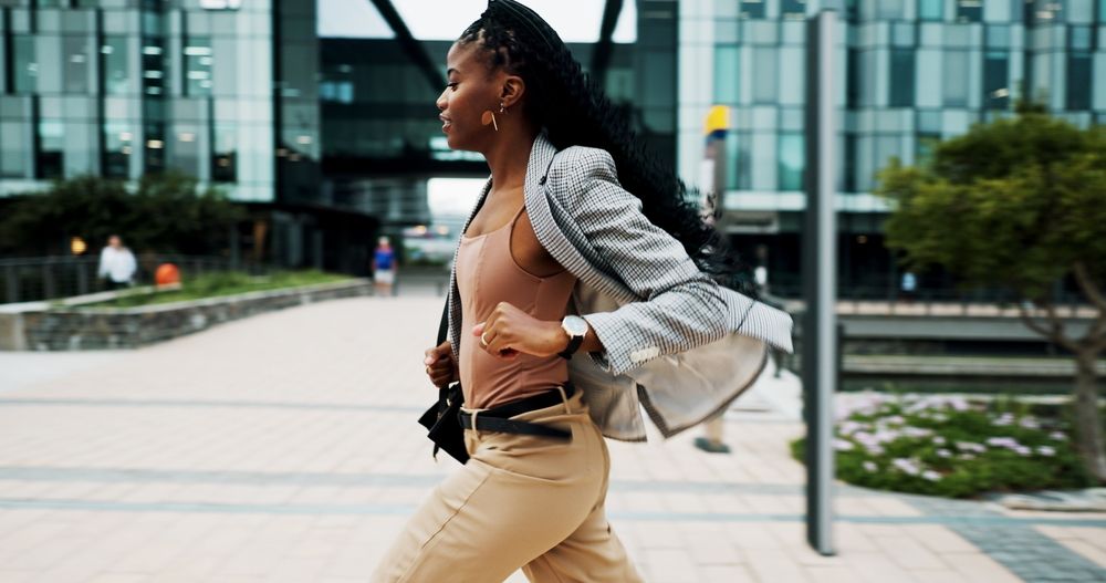 A woman running for a bus, she looks late