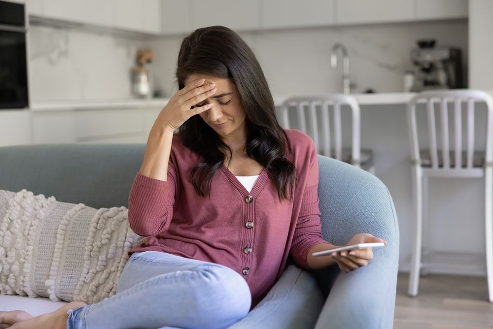 Woman looking annoyed or upset with a hand on her face